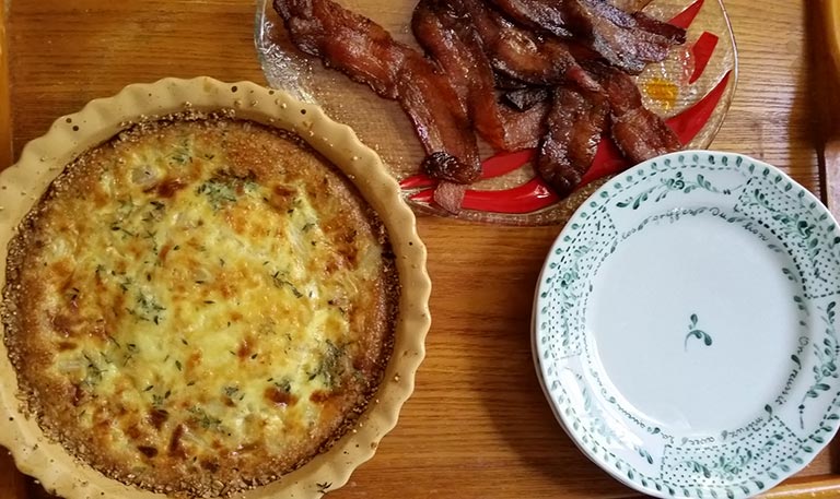 quiche on tray with bacon